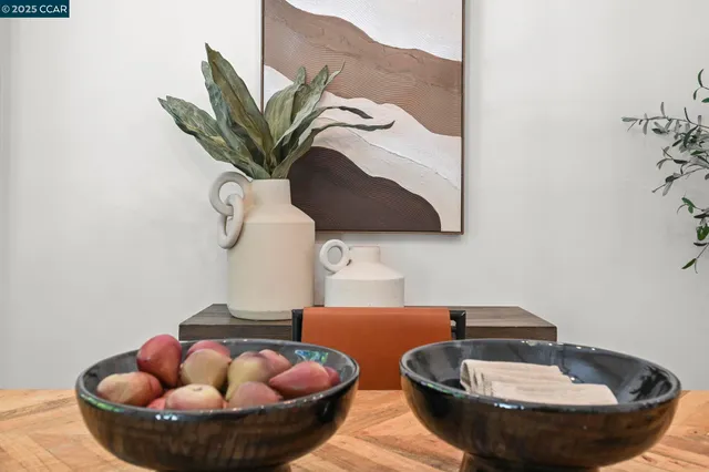 a dining room with furniture and potted plants