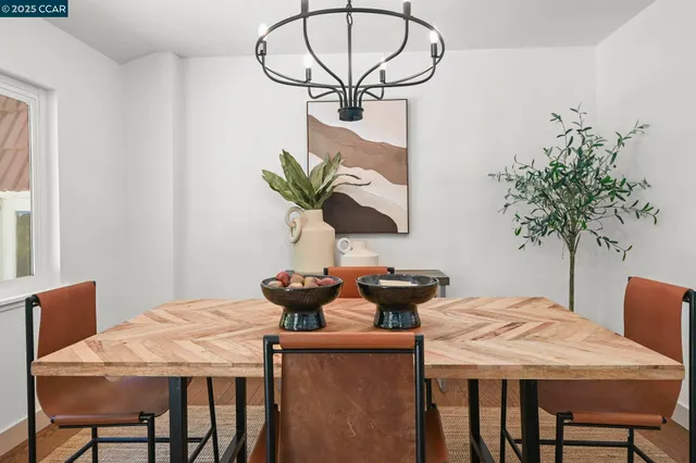 a dining room with furniture and a potted plant