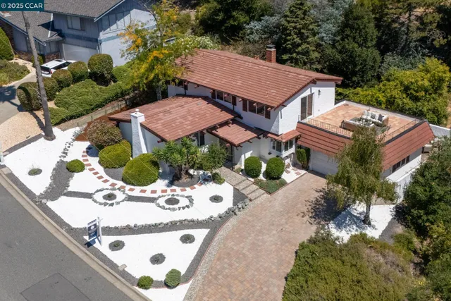 a view of a house with a yard and sitting area