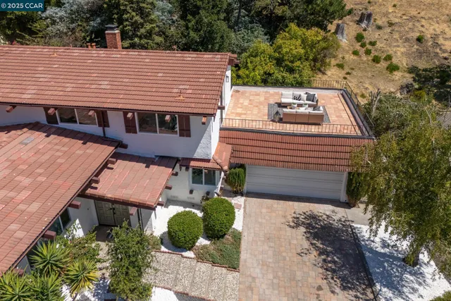 a view of a house with a yard and sitting area
