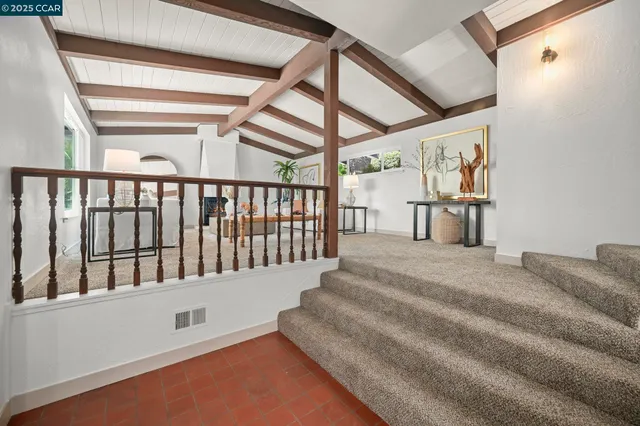 a living room with furniture a large window and table