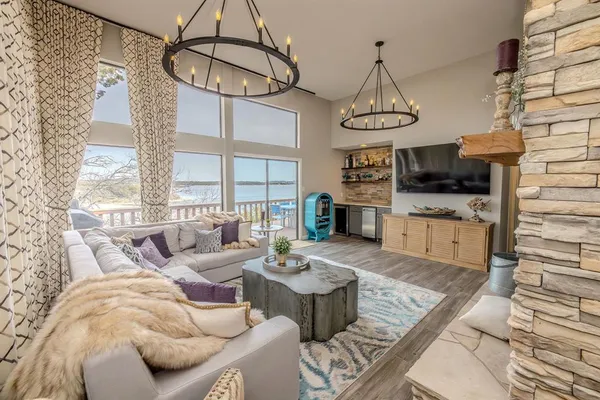 a living room with patio furniture and a chandelier