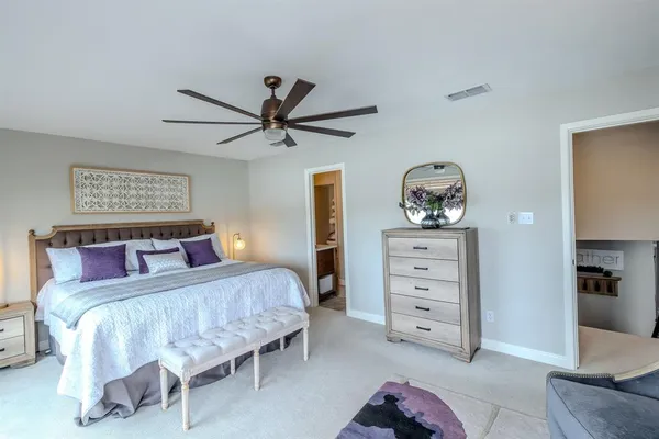 a bed sitting in a bedroom next to a window