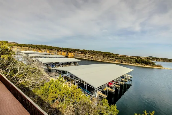 a balcony with wooden floor table and chairs