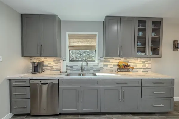 a kitchen with stainless steel appliances granite countertop a refrigerator stove microwave and cabinets