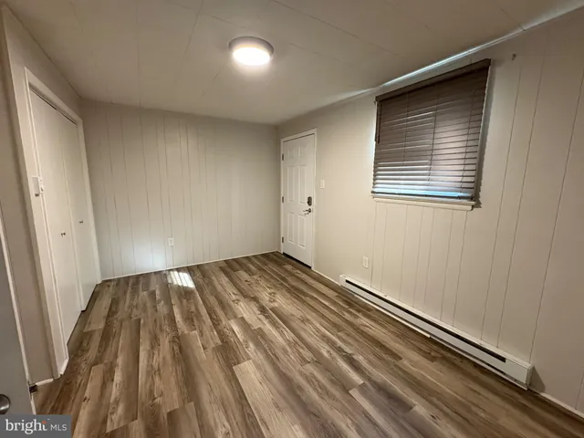 a view of a room with wooden floor