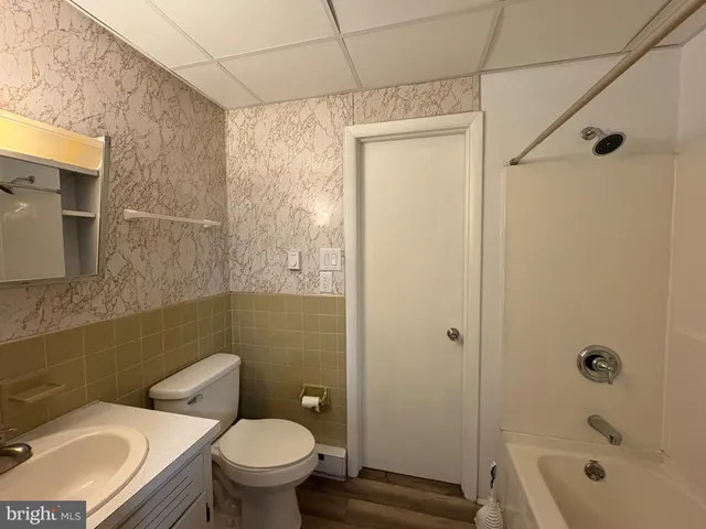 a bathroom with a toilet a sink and shower