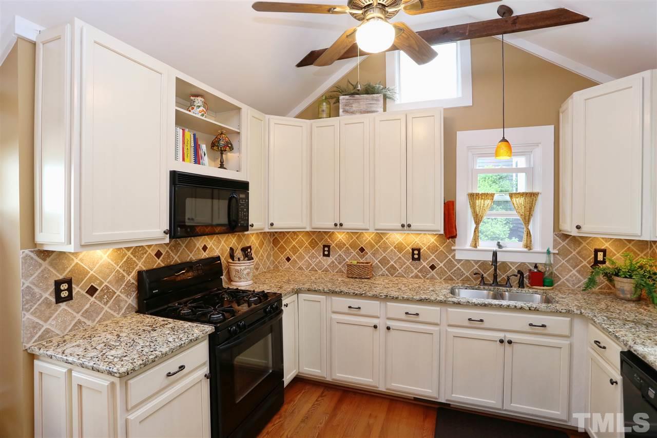 5944 Sentinel Drive Raleigh, NC 27609 - Photo 4 of 24 a kitchen with granite countertop a sink a stove and cabinets