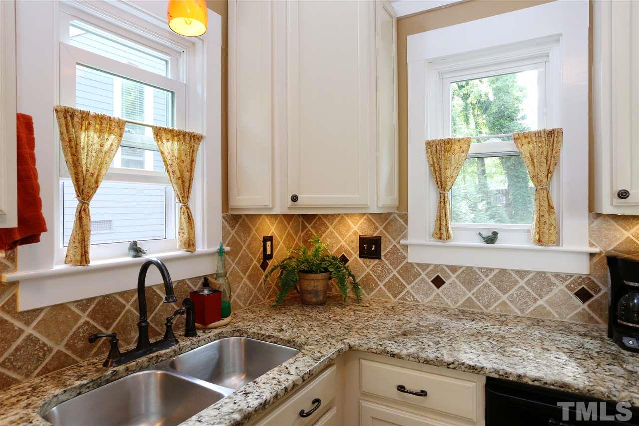 5944 Sentinel Drive Raleigh, NC 27609 - Photo 5 of 24 a kitchen with granite countertop a sink and a window