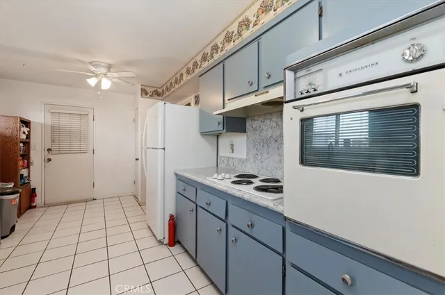 a kitchen with stainless steel appliances a refrigerator and a stove top oven