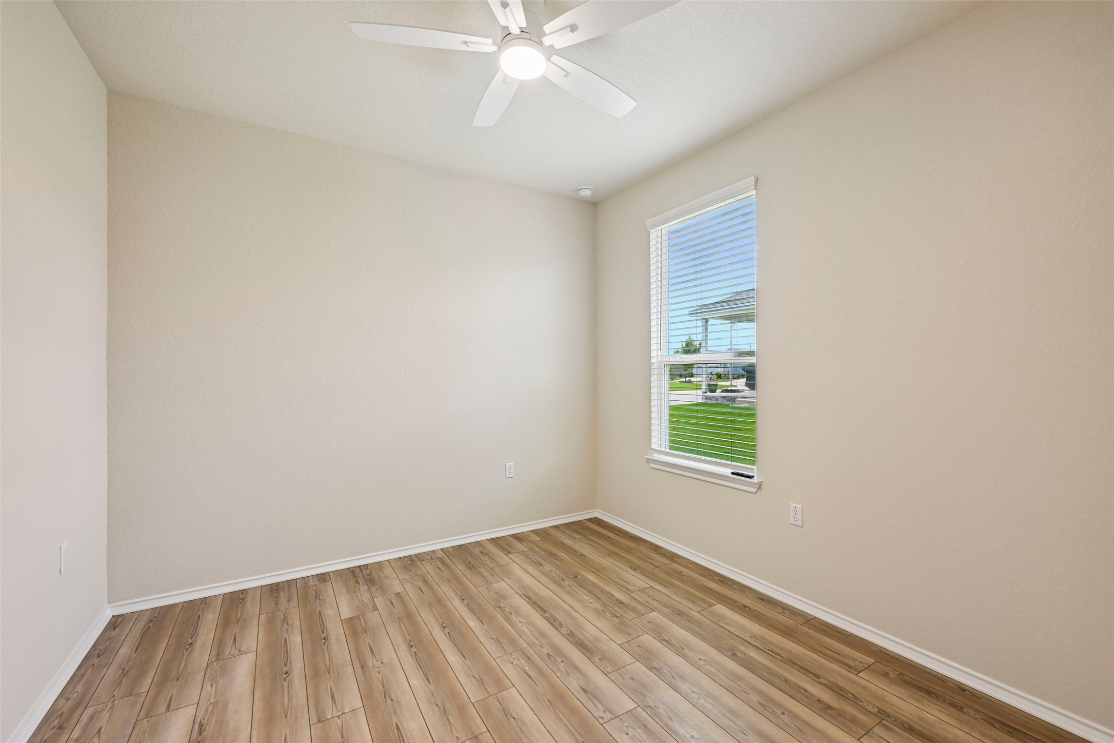 401 Yorktown Street Georgetown, TX 78633 - Photo 26 of 38 Bright room featuring wood-finish flooring, neutral wall tones, and a ceiling fan