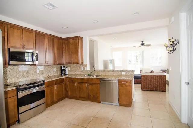 a kitchen with stainless steel appliances granite countertop a sink and cabinets