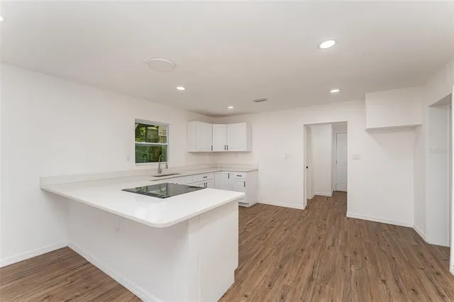 a kitchen that has a sink and a stove in it