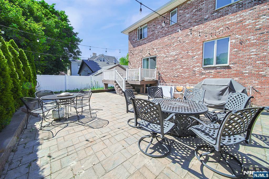 897 Virgil Avenue Ridgefield, NJ 07657 - Photo 5 of 50 a view of a patio with table and chairs and potted plants