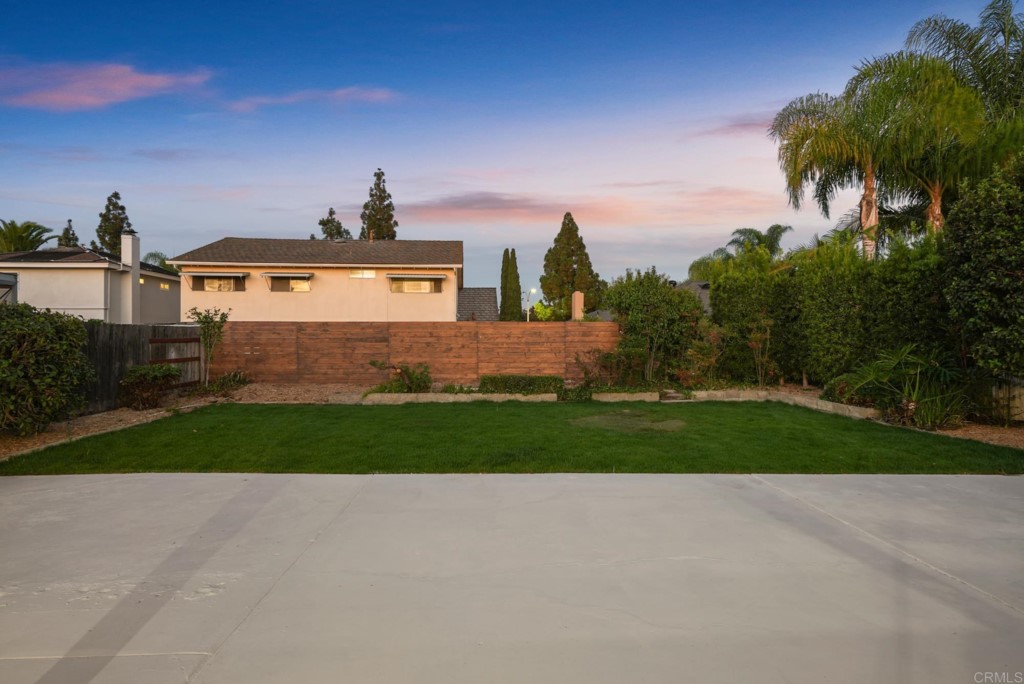 6125 Laport Street La Mesa, CA 91942 - Photo 21 of 32 a view of a house with a yard and palm trees
