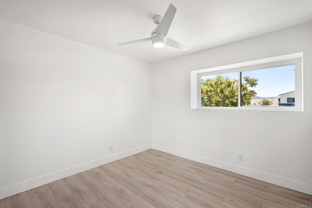 6125 Laport Street La Mesa, CA 91942 - Photo 30 of 32 an empty room with wooden floor fan and windows