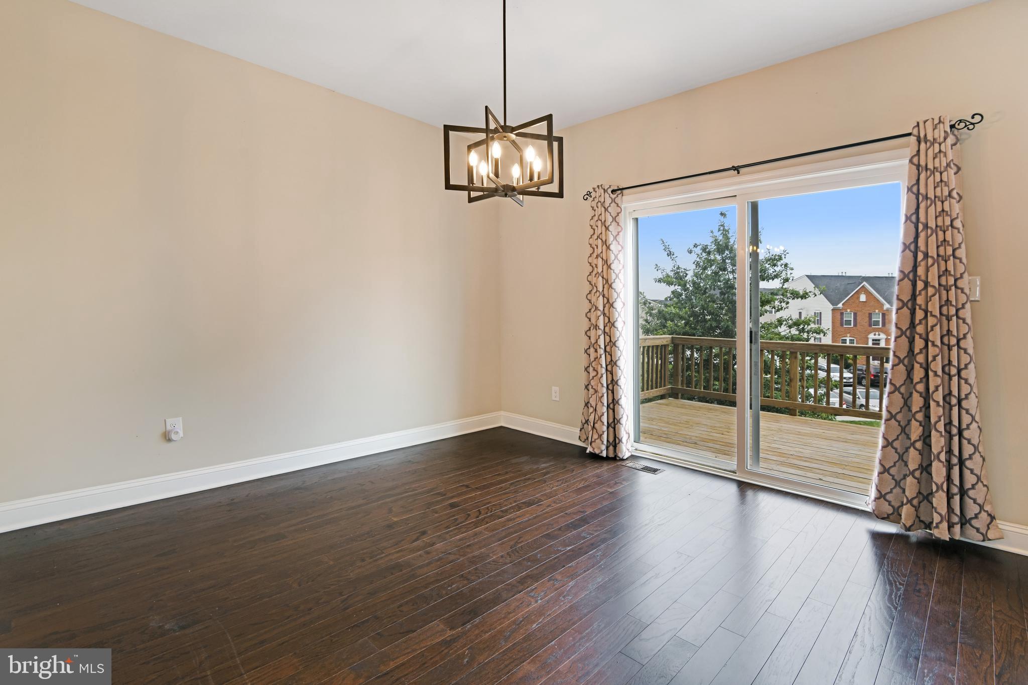 4654 Cambria Road Frederick, MD 21703 - Photo 6 of 18 a view of an empty room with wooden floor and a window