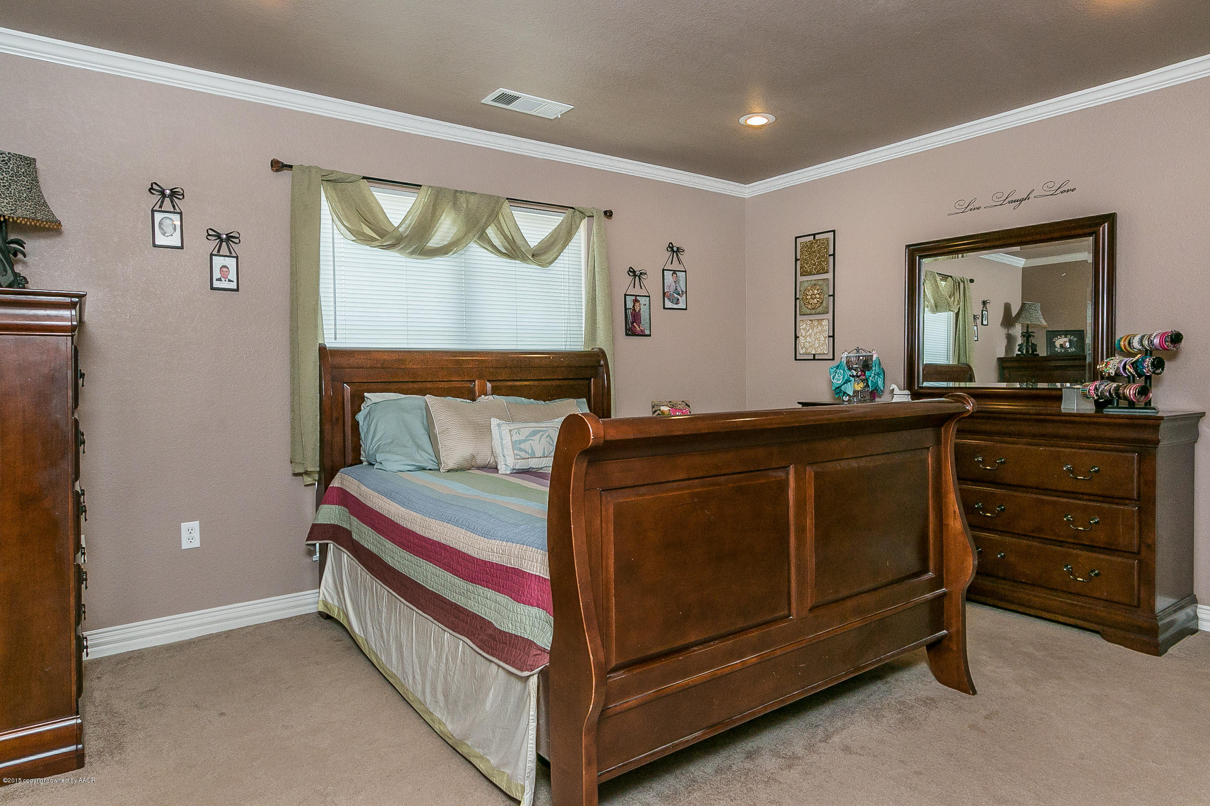 5301 Pleasant Court Amarillo, TX 79110 - Photo 12 of 28 a bed room with a bed and a dresser