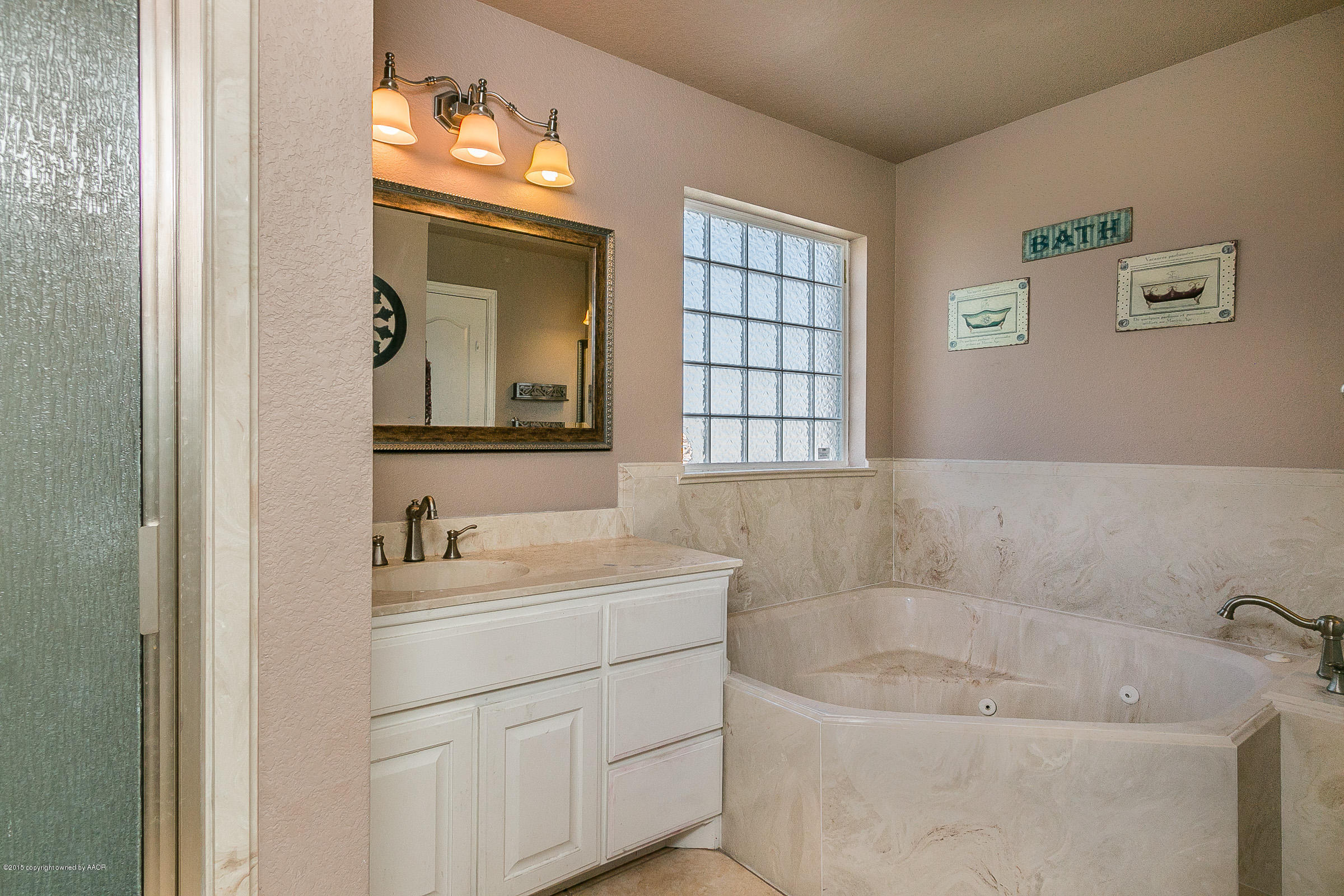 5301 Pleasant Court Amarillo, TX 79110 - Photo 13 of 28 a bathroom with a sink and a mirror