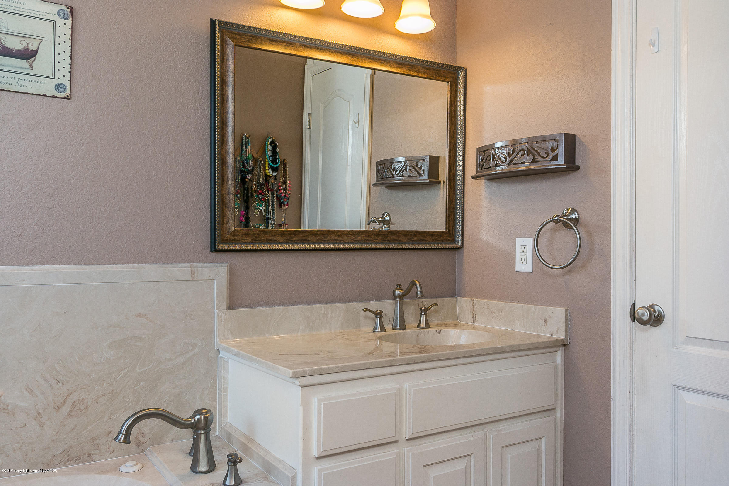 5301 Pleasant Court Amarillo, TX 79110 - Photo 14 of 28 a bathroom with a granite countertop sink and a mirror