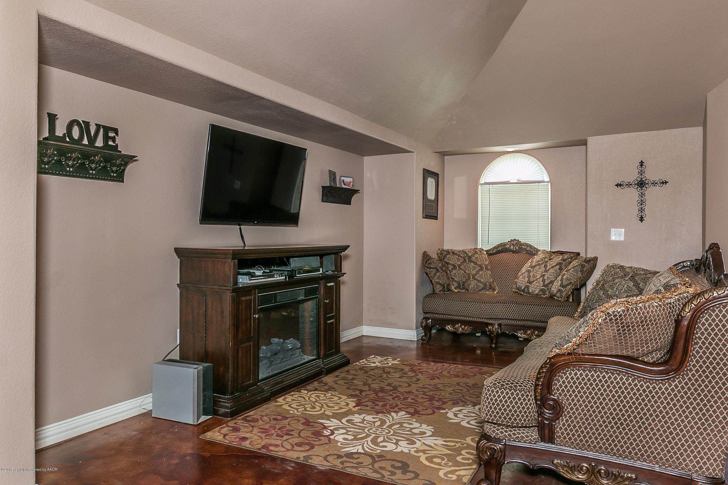 5301 Pleasant Court Amarillo, TX 79110 - Photo 5 of 28 a living room with furniture a flat screen tv and a fireplace