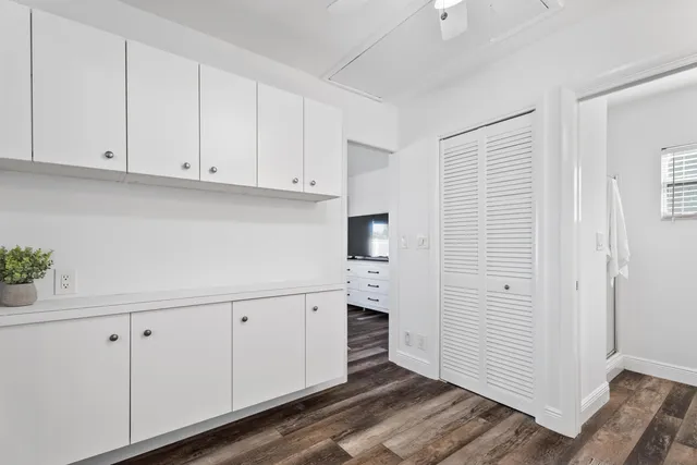 a kitchen with stainless steel appliances white cabinets and a window