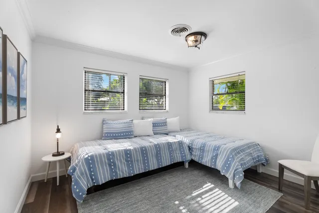 a bedroom with a bed lamp and a window