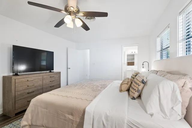 a bedroom with a bed and a flat screen tv