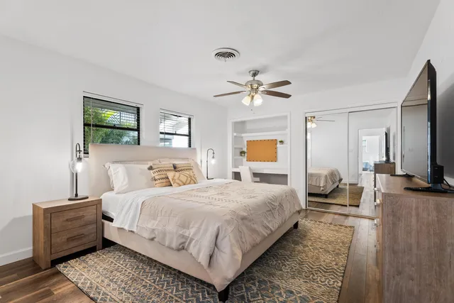 a bedroom with a large bed and a chandelier