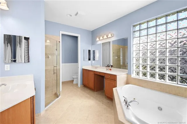 a bathroom with a tub sink and mirror