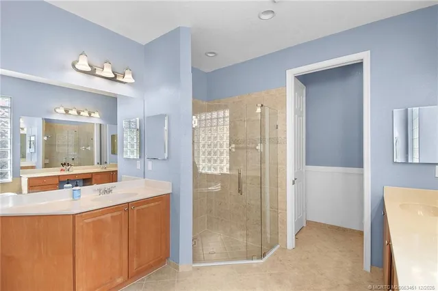 a bathroom with a tub sink shower and mirror