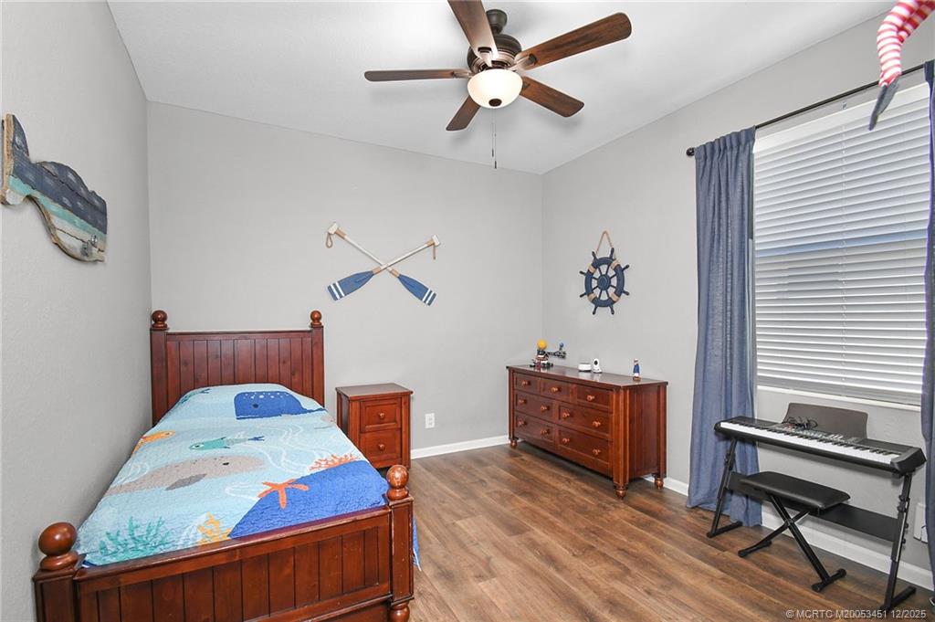 3141 Southwest Porpoise Circle Stuart, FL 34997 - Photo 15 of 45 a living room with furniture and a chandelier
