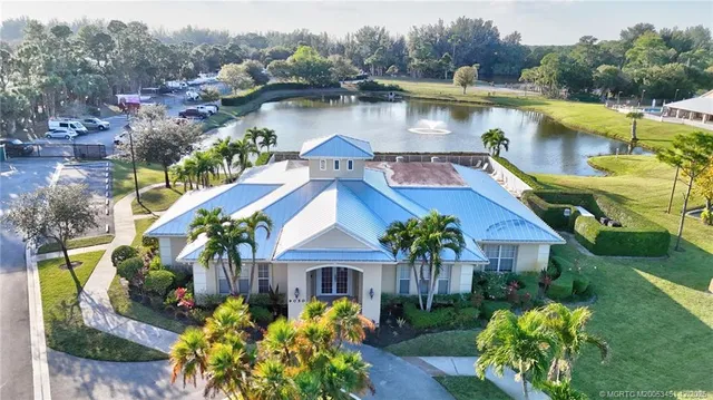 an aerial view of a house with swimming pool and outdoor seating