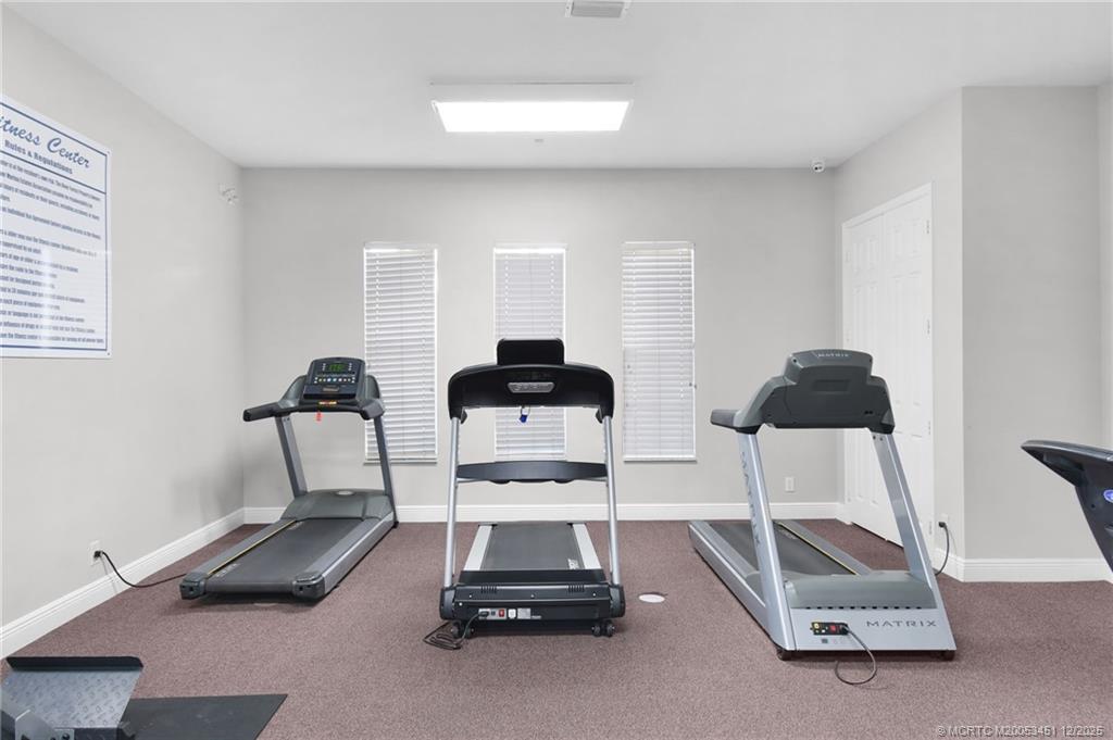3141 Southwest Porpoise Circle Stuart, FL 34997 - Photo 24 of 45 a room with gym equipment and a mirror