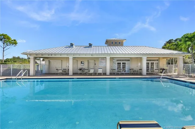 a front view of house with yard barbeque and outdoor seating