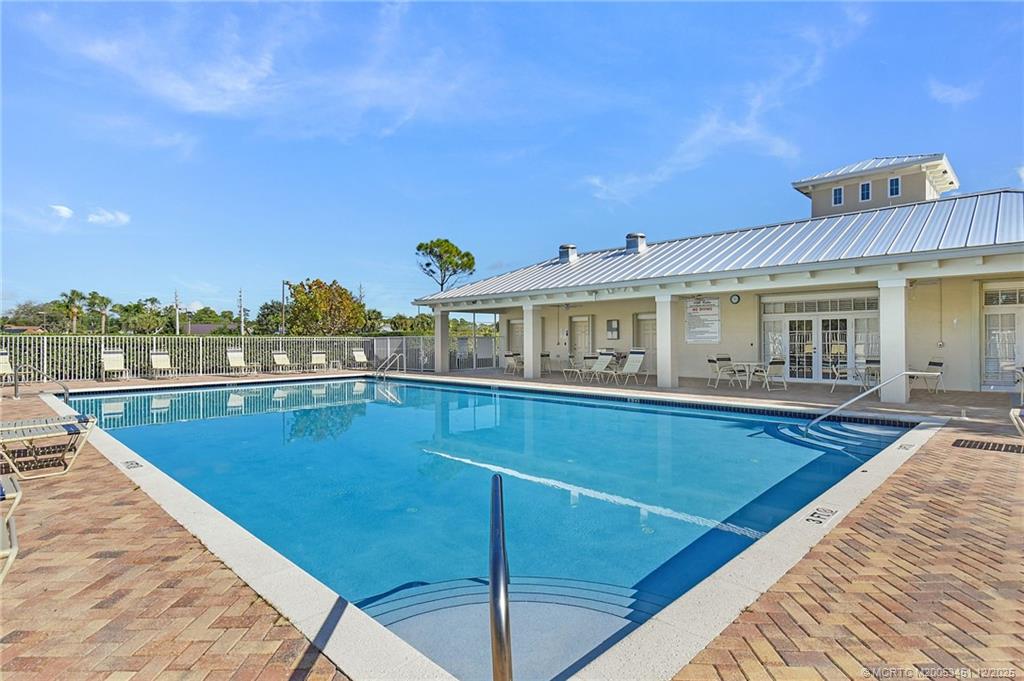 3141 Southwest Porpoise Circle Stuart, FL 34997 - Photo 29 of 45 a view of a swimming pool with an outdoor seating