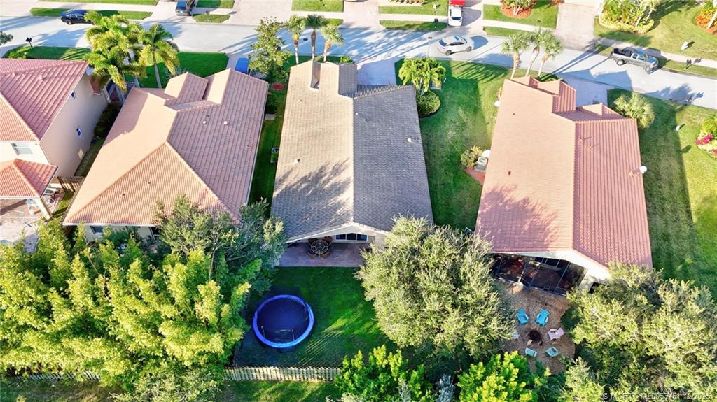3141 Southwest Porpoise Circle Stuart, FL 34997 - Photo 35 of 45 an aerial view of a house with swimming pool and garden
