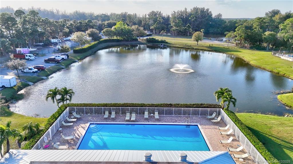 3141 Southwest Porpoise Circle Stuart, FL 34997 - Photo 39 of 45 a view of swimming pool with outdoor seating and lake view