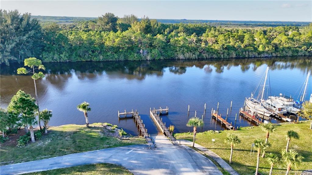 3141 Southwest Porpoise Circle Stuart, FL 34997 - Photo 41 of 45 a view of a lake with a sitting area