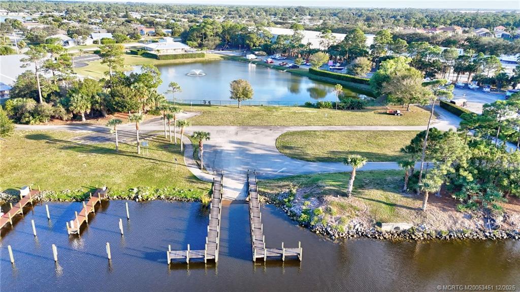 3141 Southwest Porpoise Circle Stuart, FL 34997 - Photo 42 of 45 an aerial view of residential houses with outdoor space and lake view
