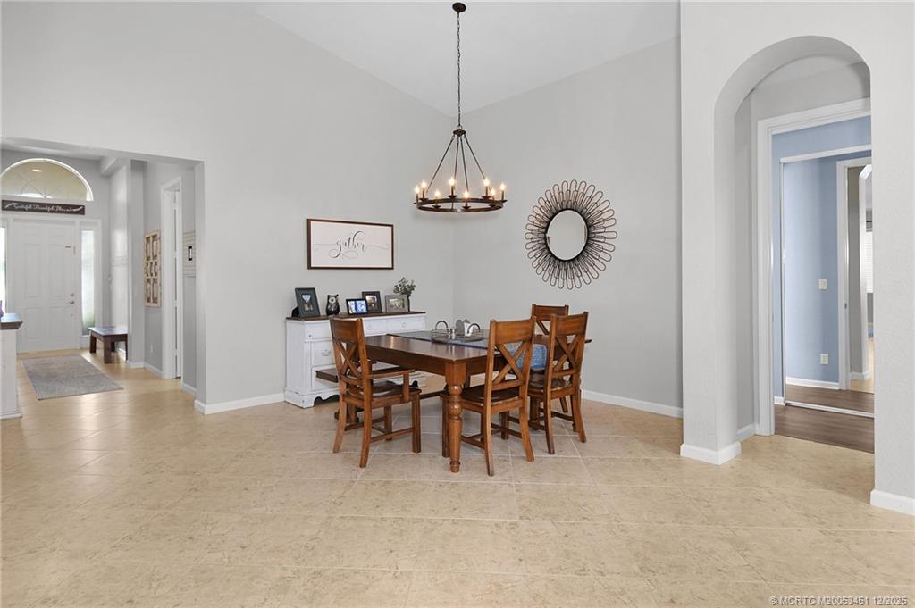 3141 Southwest Porpoise Circle Stuart, FL 34997 - Photo 7 of 45 a view of a dining room with furniture and wooden floor