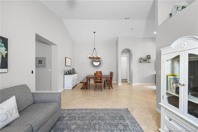 a living room with furniture and a dining table
