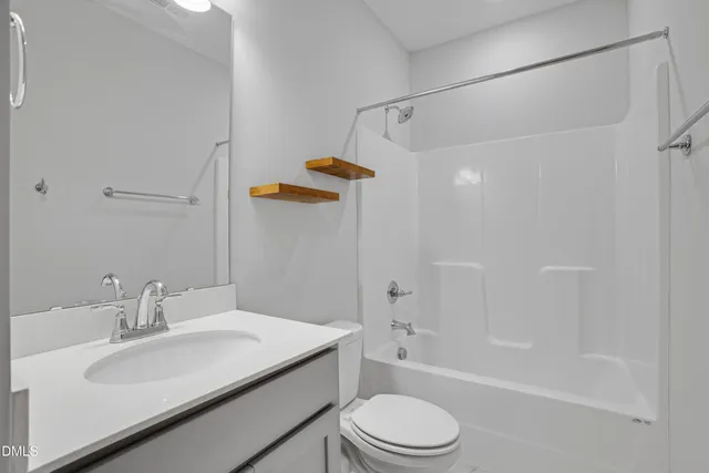 a view of a hallway with furniture and shower