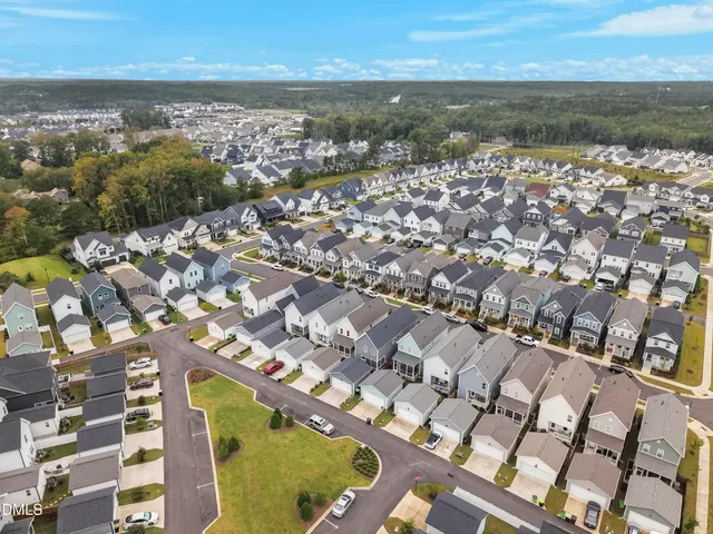 an aerial view of residential houses with outdoor space