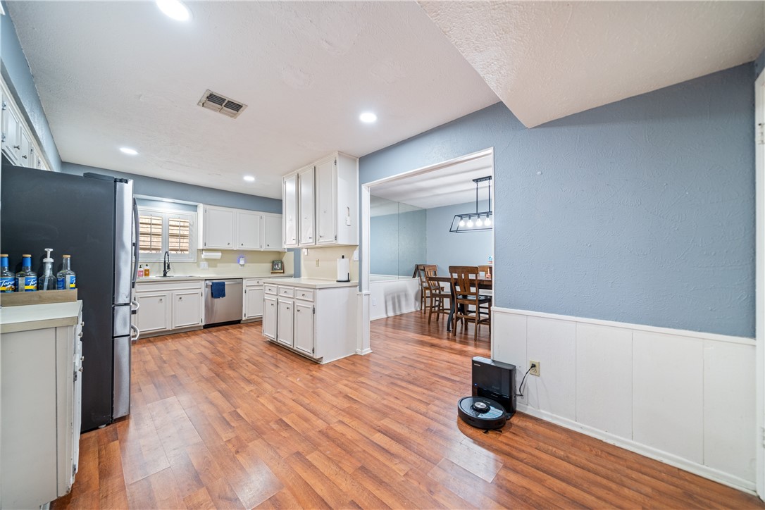 2217 Post Oak Drive Portland, TX 78374 - Photo 9 of 39 a kitchen with stainless steel appliances a dining table chairs and a refrigerator
