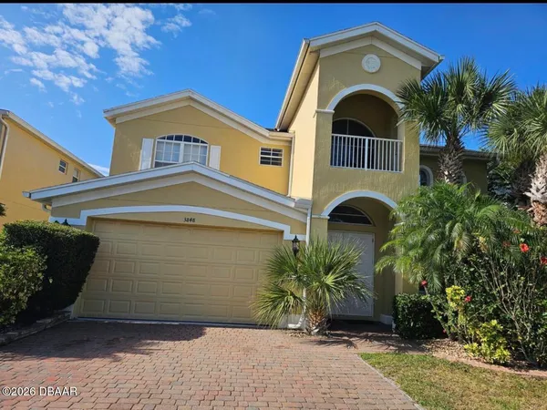 a front view of a house with a garden