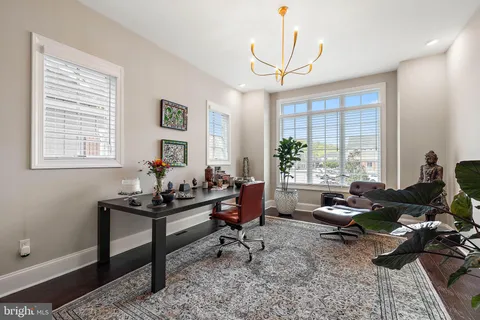 a view of a hallway with wooden floor and entryway