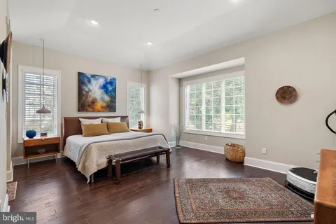 a bedroom with a bed and a table with potted plant