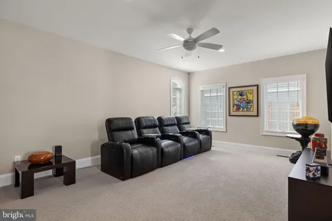 a spacious bedroom with a bed and glass window