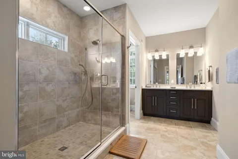 a bathroom with a sink vanity and a mirror